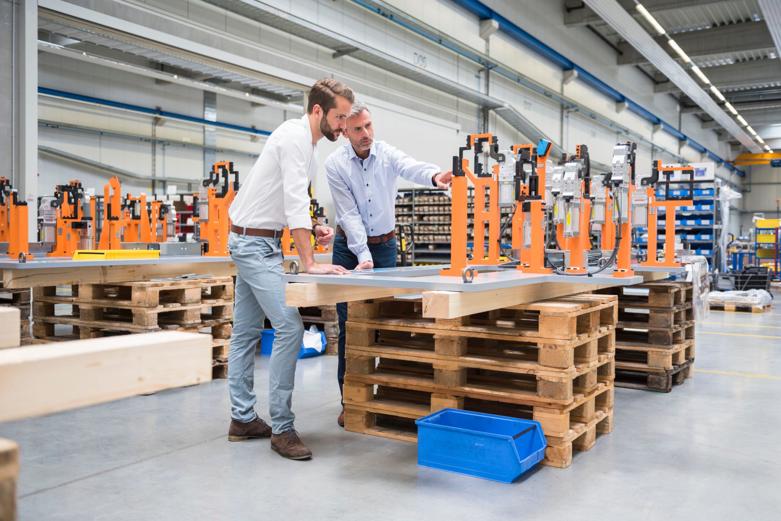 2C440RF Two men talking on factory shop floor